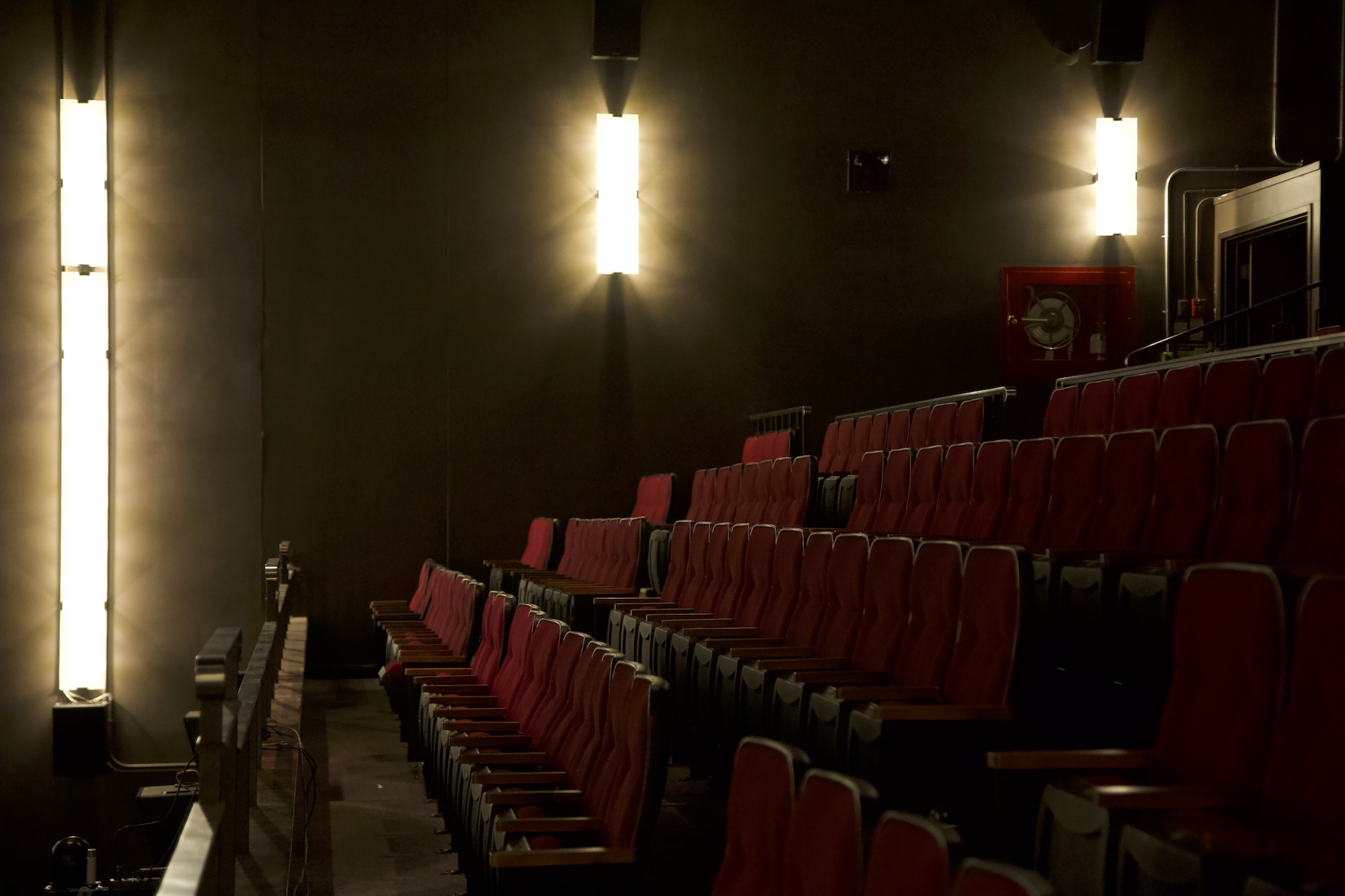 The Chrysalis auditorium seen from the stage, every red seat empty.