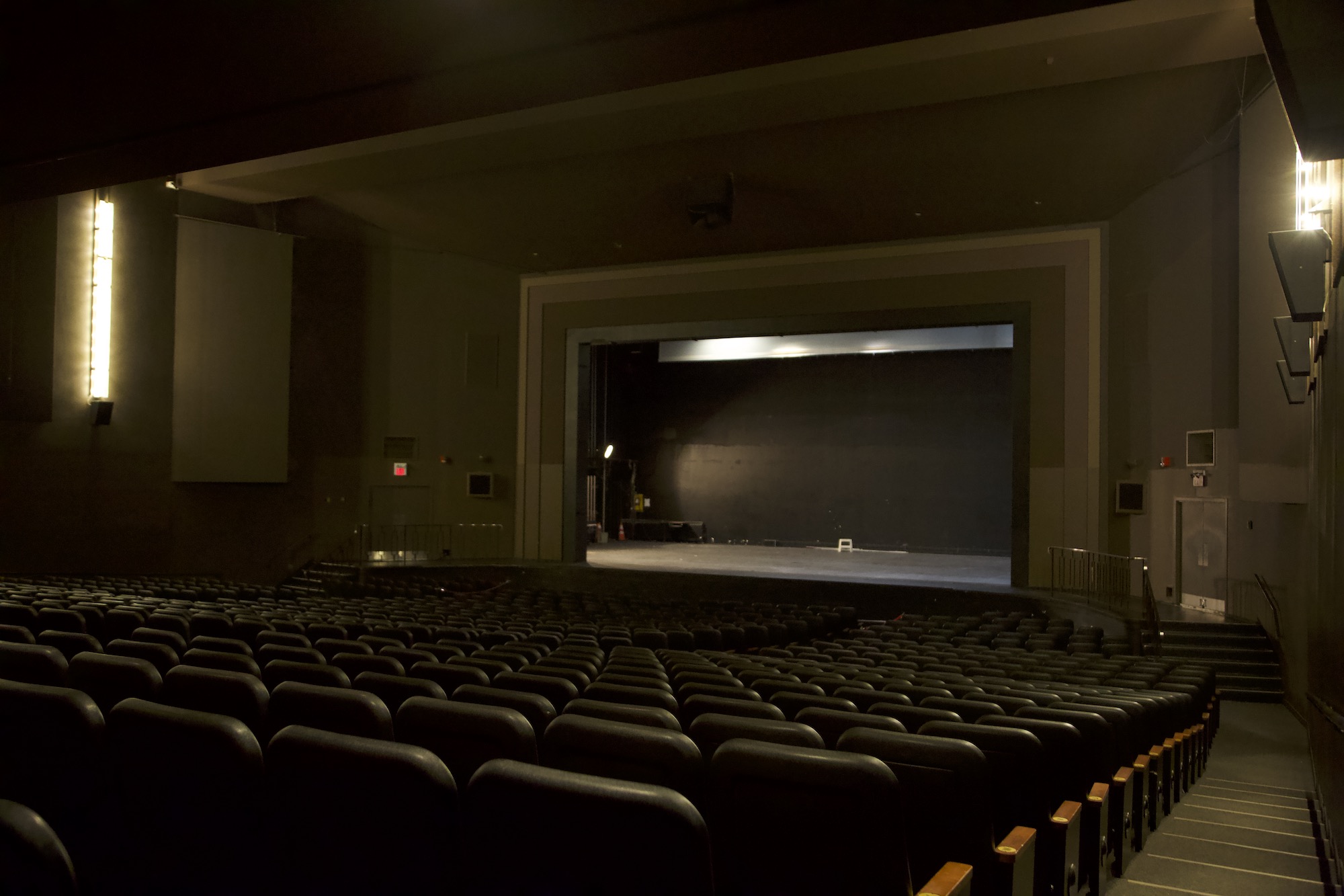 The house of the theatre seen from the centre, looking toward the lit proscenium opening
