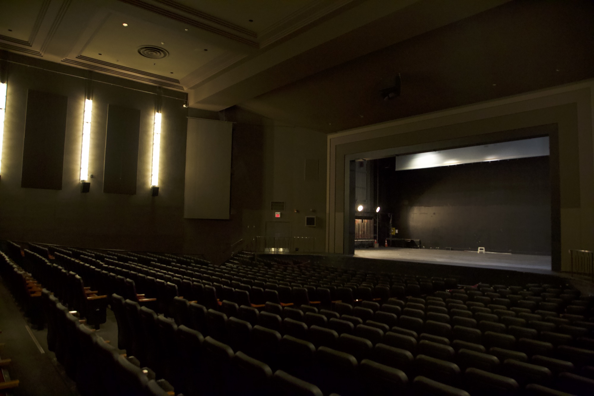 The grand house at Chrysalis, orchestra level and balcony filled with red seats.