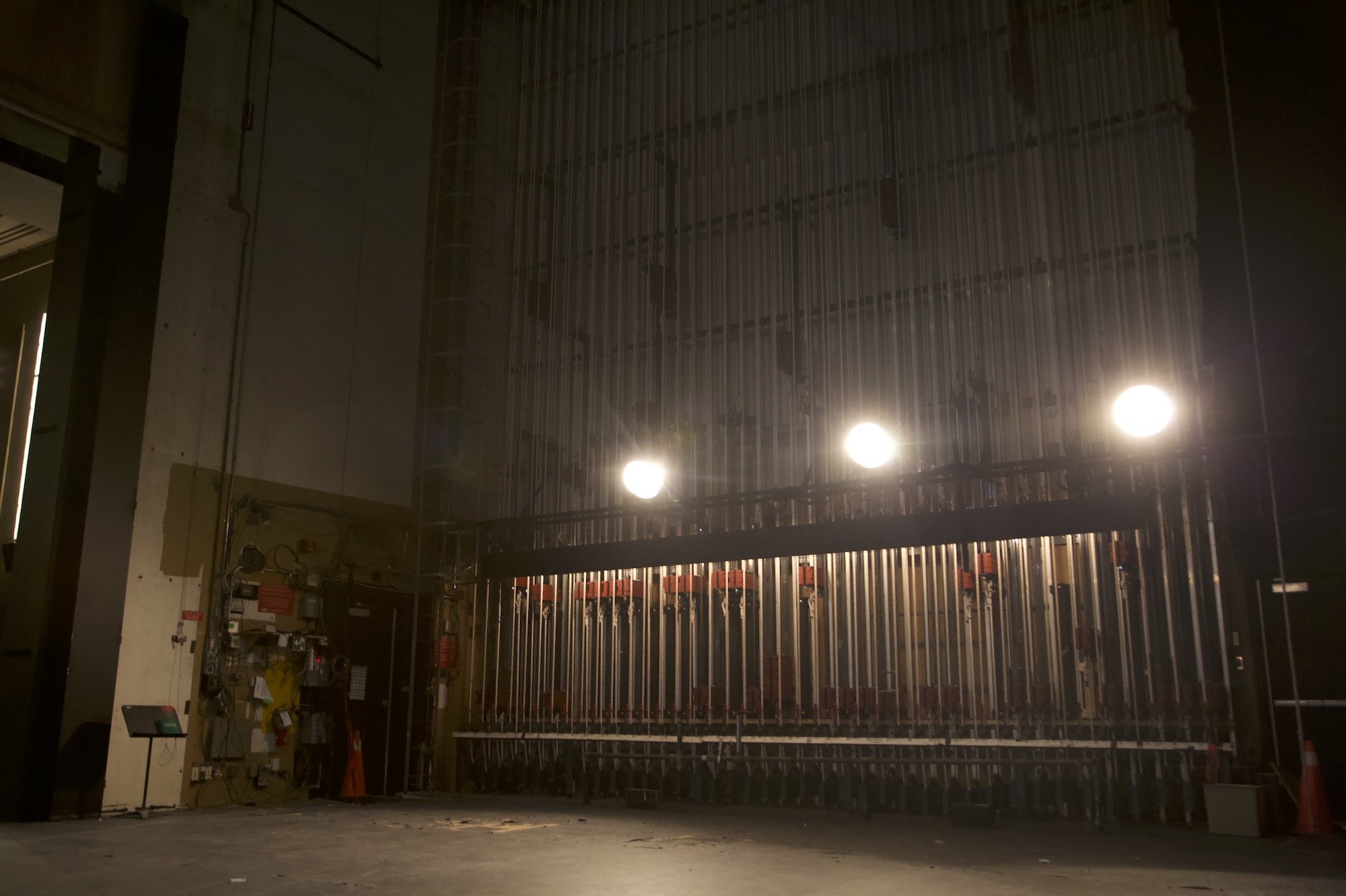 A close-up of the numbered pin rail and rope locks of the fly system