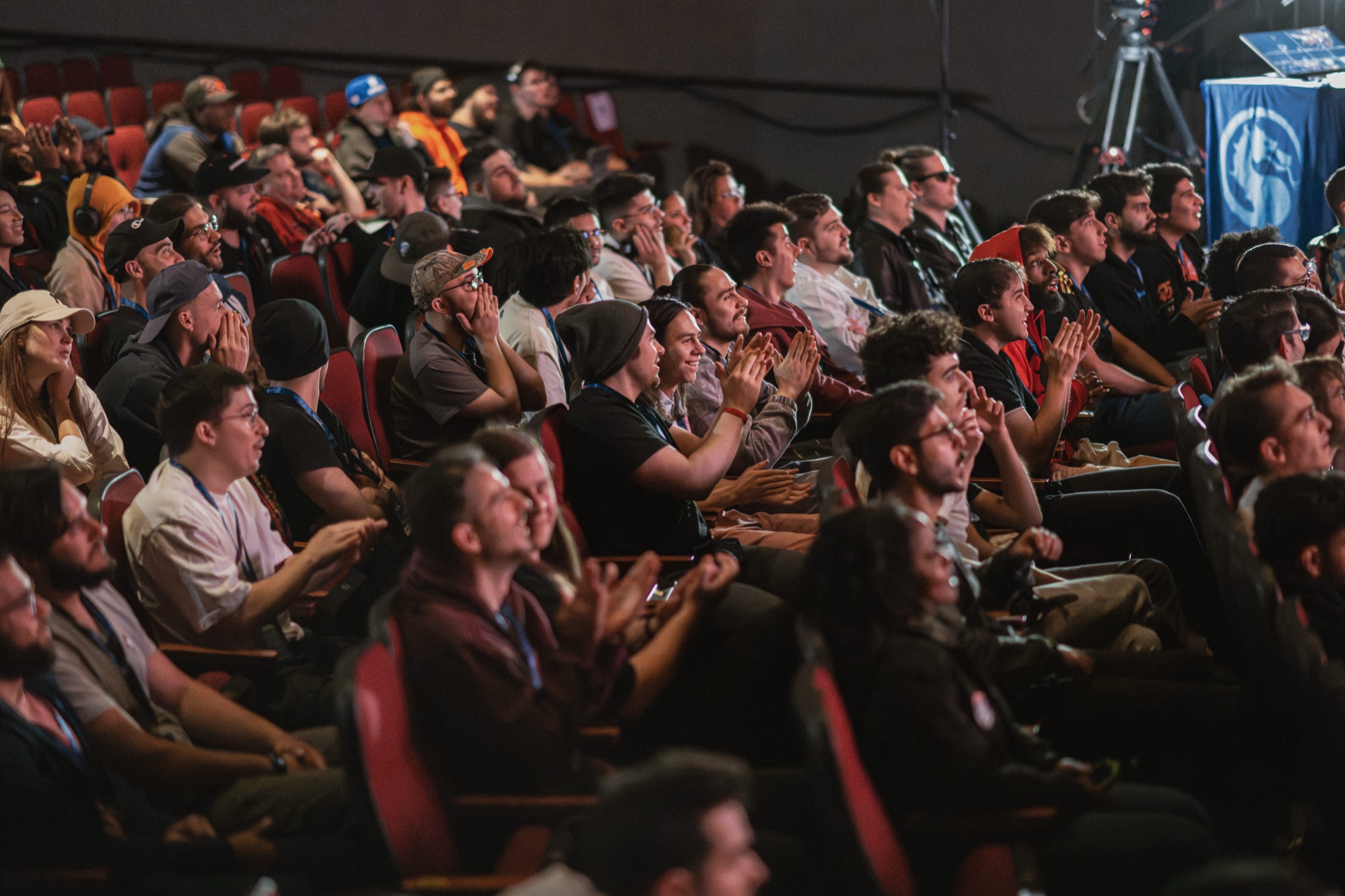 A packed young audience applauding at a live gaming event