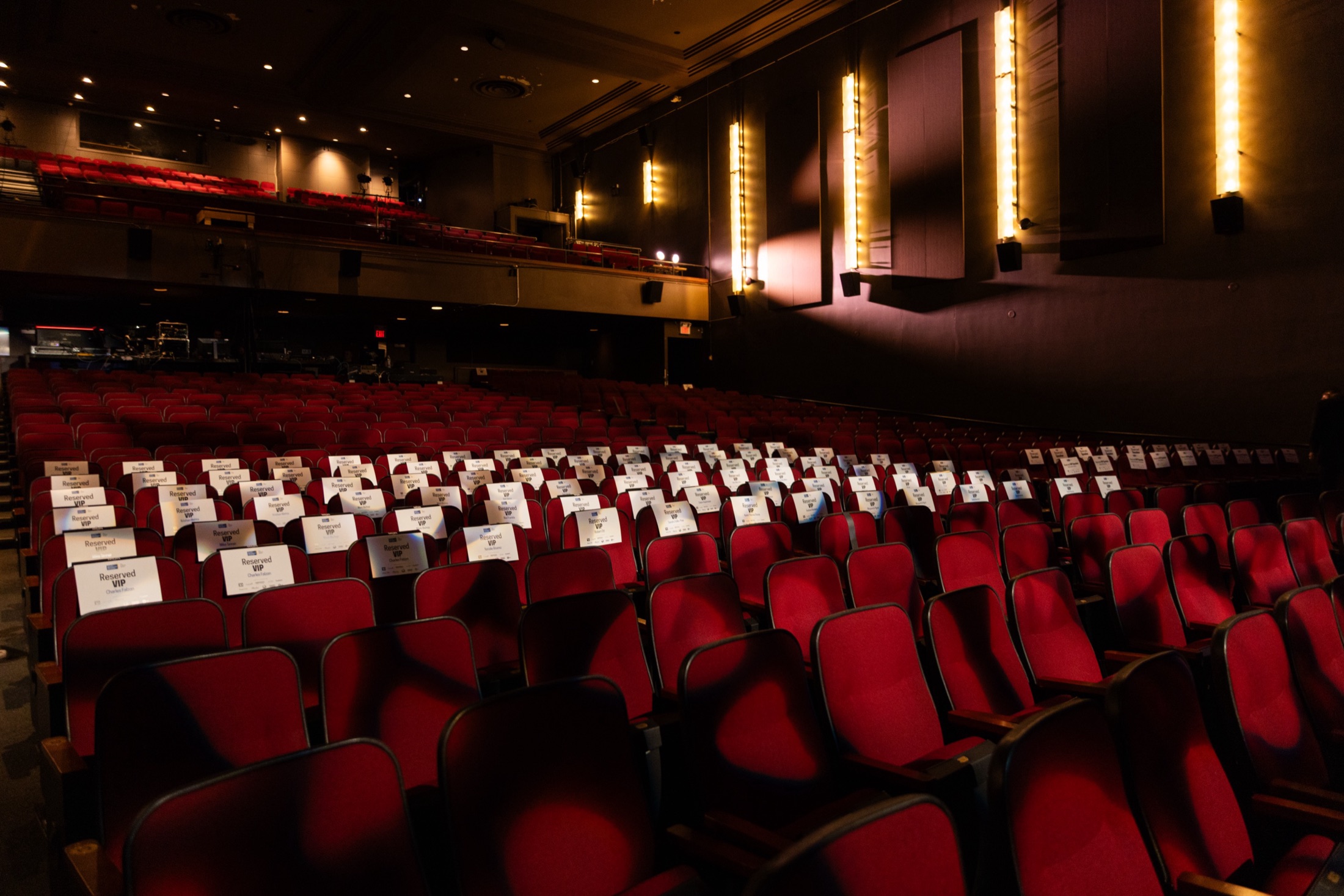 Reserved seat cards on the red velvet seats of the Chrysalis auditorium